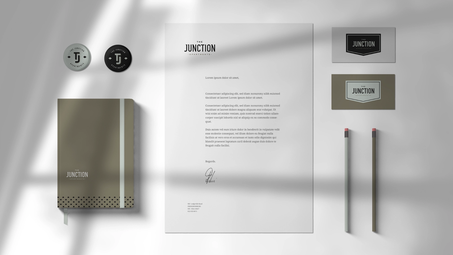Stationery and branding mockup for The Junction Apartments.