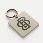 Square keychain with abstract logo design.