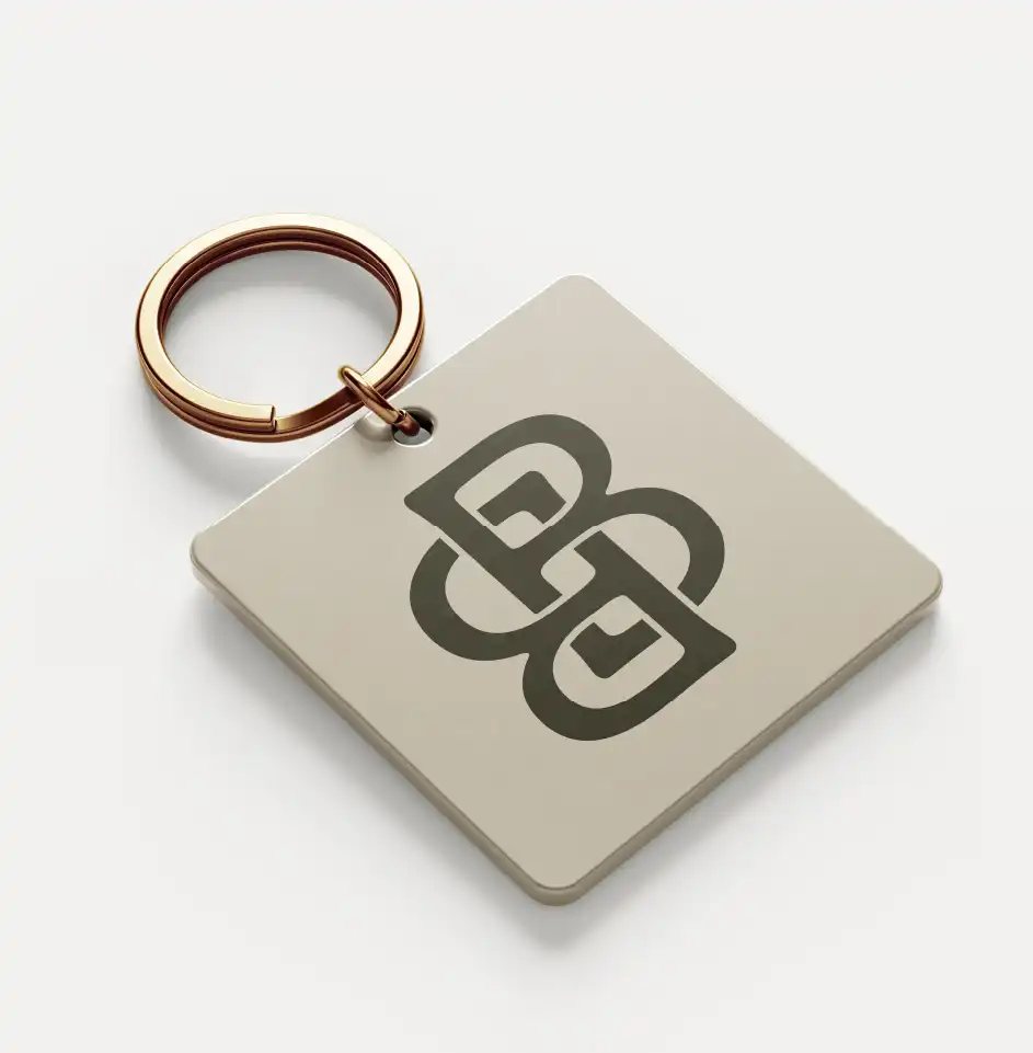 Square keychain with abstract logo design.