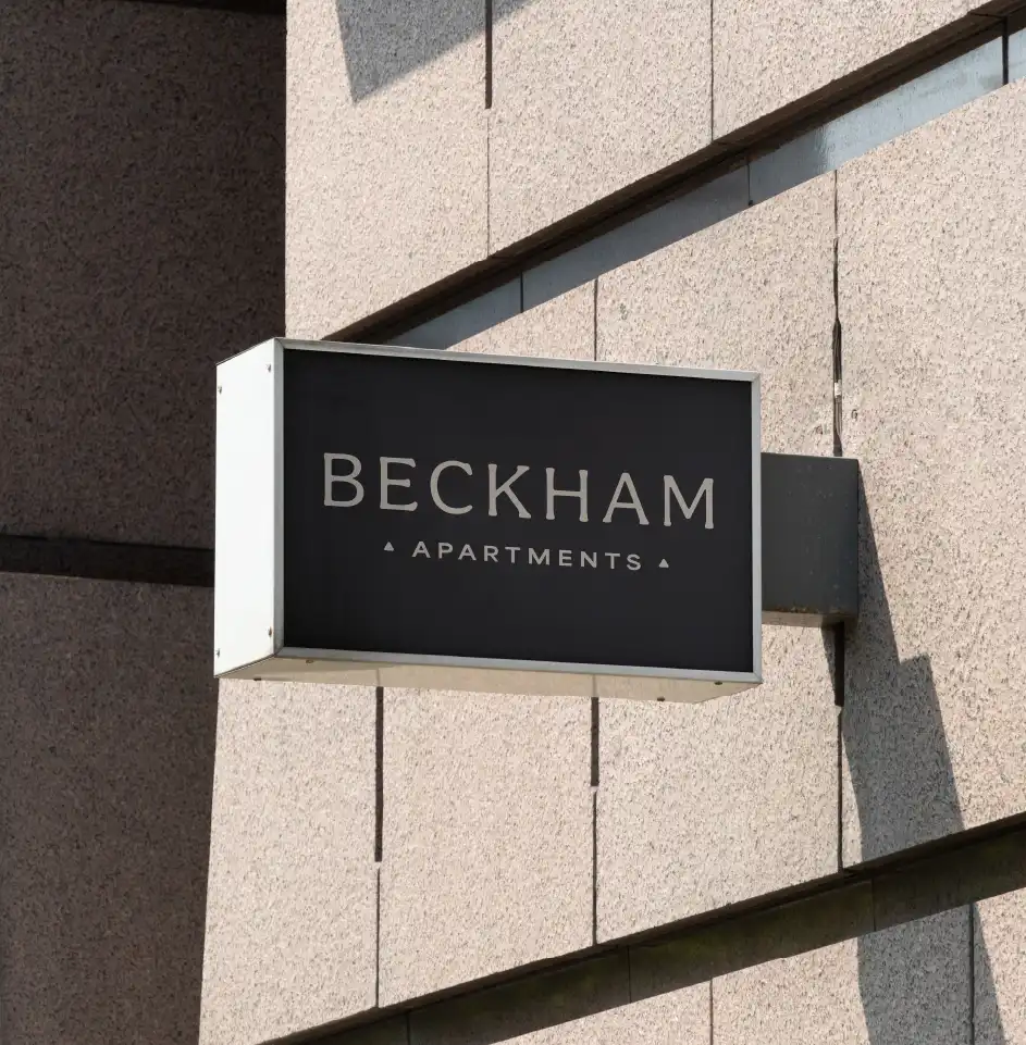 Sign of Beckham Apartments on building wall.