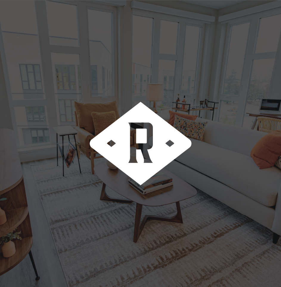 Modern living room with large windows, stylish furniture.