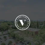 The Vida Downtown Living logo over cityscape.