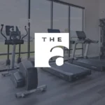 Modern gym with exercise equipment and large windows