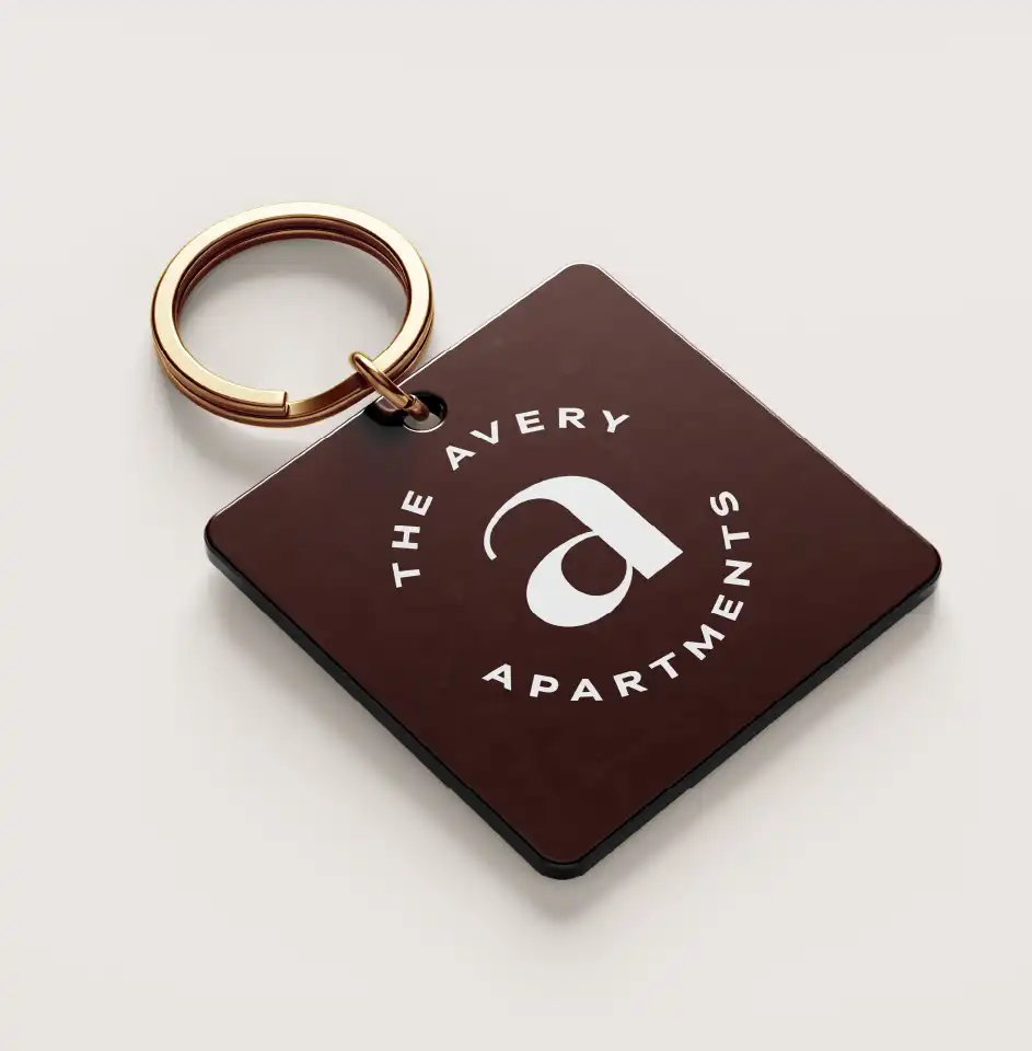 The Avery Apartments keychain on white background.