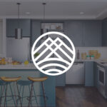 Modern kitchen with wooden stools and stylish design.