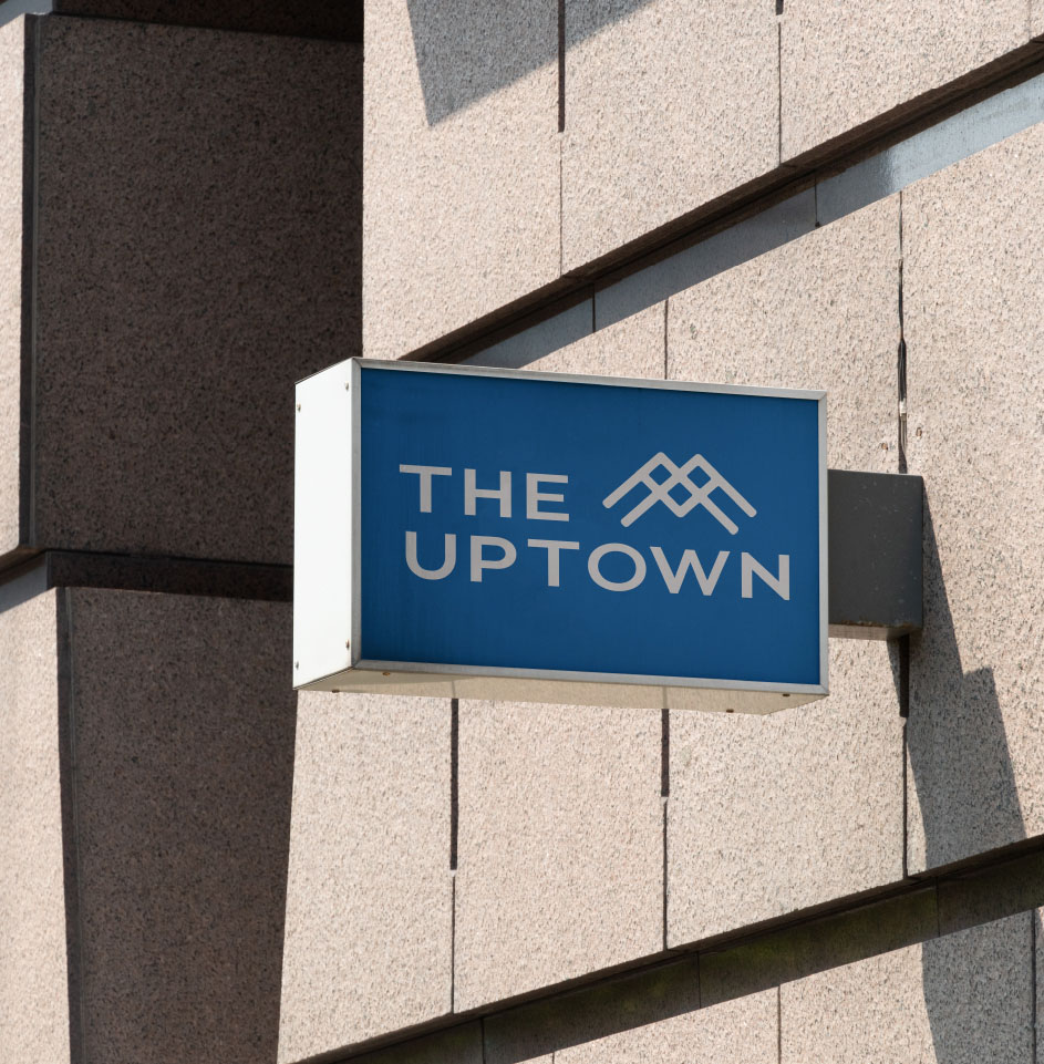 The Uptown building sign in blue and white.